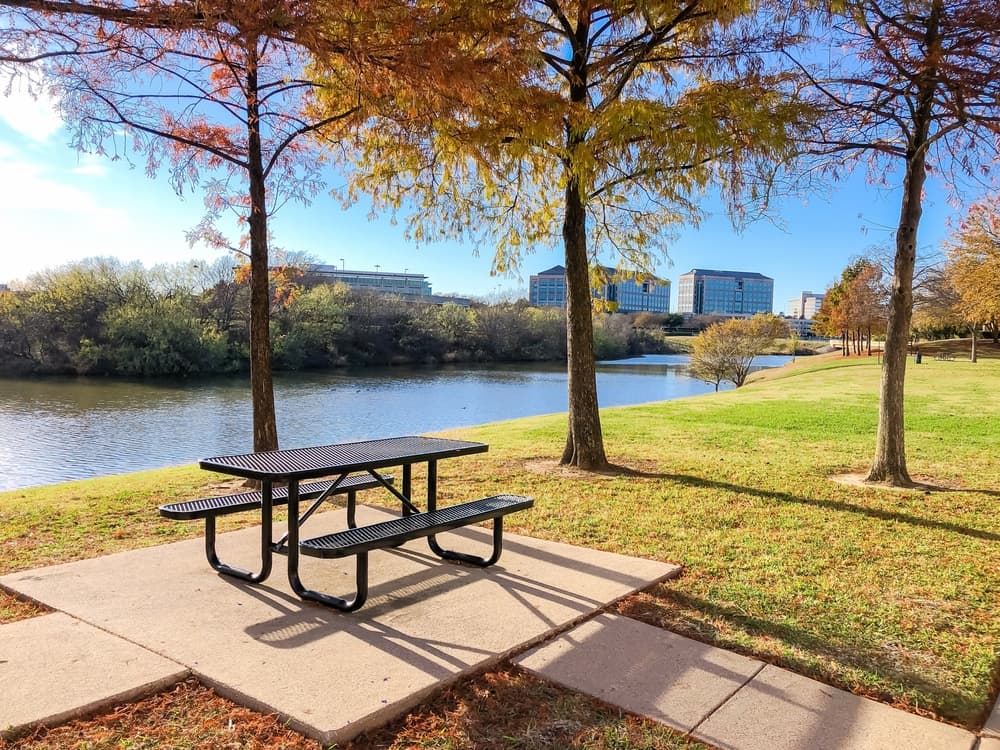park with a lake and picnic table featuring bald cypress